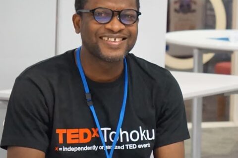 Young smiling African man wearing a black TEDx tee shirt