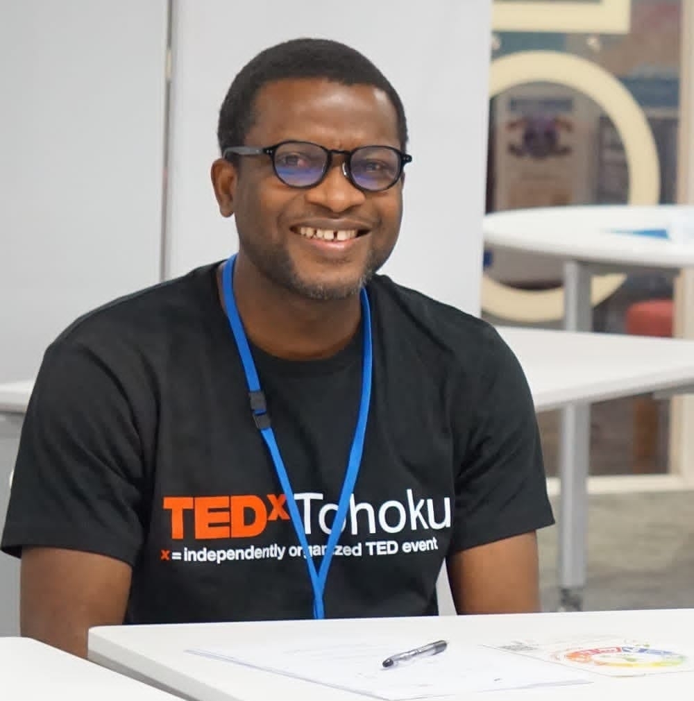 Young smiling African man wearing a black TEDx tee shirt